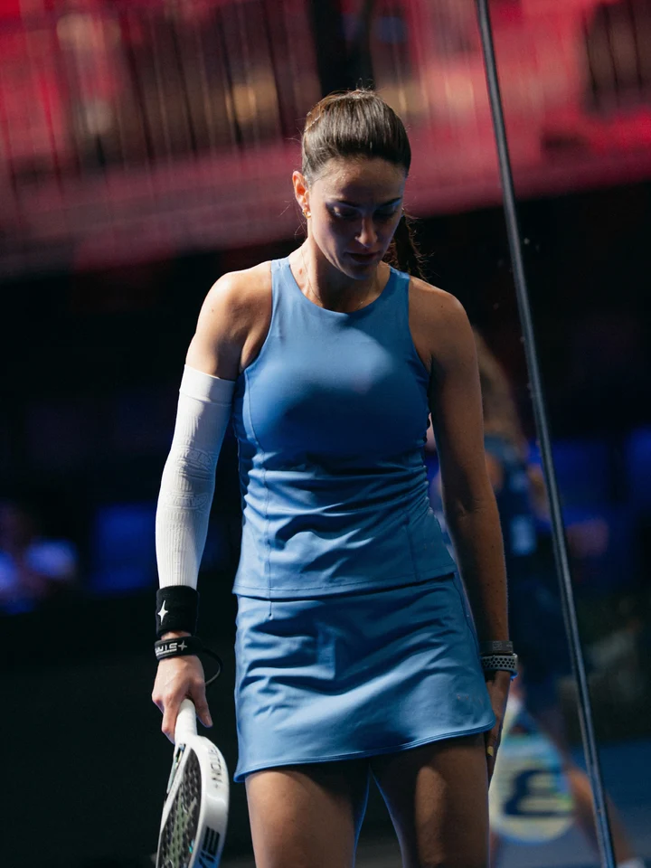 A padel player focused between points