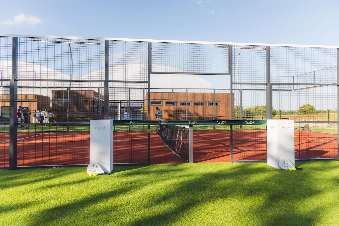 Tizona Sport Club’s actual outdoor red padel court, framed by its glass walls and green surroundings